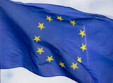 Fototapeta  - Official flag of the European Union in front of a blue sky