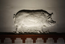 Pig Bas-relief On The Wall. Image In The Night. Successful Animal Husbandry Concept. Side View