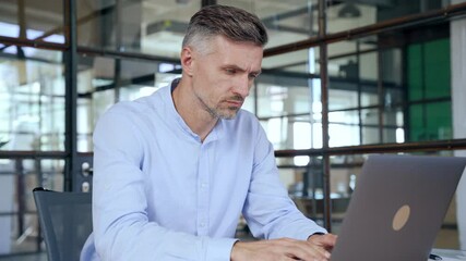 Wall Mural - Focused busy mature business man lawyer ceo trader using computer, typing, working in modern office room doing online data market analysis, thinking planning tech strategy looking at laptop.