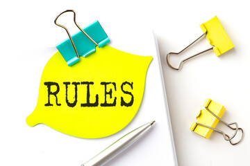 Aufkleber - RULES text on yellow sticker on the notebook with pen