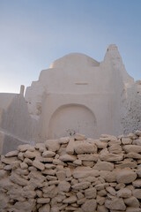 Wall Mural - Mykonos island famous old church, Panagia Paraportiani at sunrise. Cyclades, Greece.