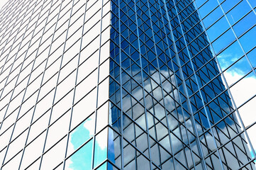 Architecture abstract of a blue glass wall of a skyscraper.