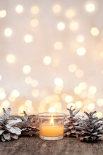 Christmas Decoration Pine Cones And Candle On A Wooden Background. Vertical Photo
