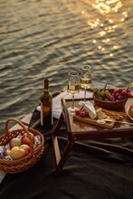 Amazing Sunset On The Lake, White Wine, Fruit Cake, Apples, Grapes, Brie Cheese, Biscuits. Autumn Aesthetic Picnic.