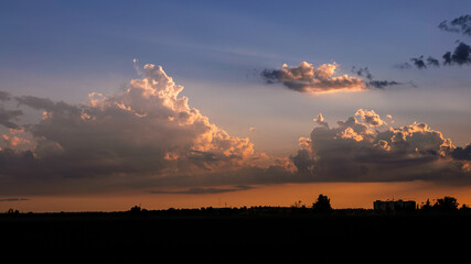 Wall Mural - Wonderful view of cumulus clouds sky with orange sun light at sunset of summer