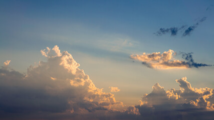 Wall Mural - Wonderful view of cumulus clouds sky with orange sun light at sunset of summer