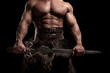 © Fotokvadrat - Close up muscular ancient warrior barbarian with fantasy sword on black background