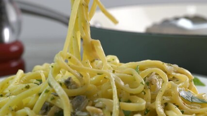 Canvas Print - Eating a forkful of linguine with clam sauce close up
