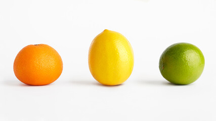 Wall Mural - Mandarin, lemon and lime on a white background.