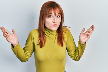 Sticker - Redhead young woman wearing turtleneck sweater clueless and confused with open arms, no idea and doubtful face.