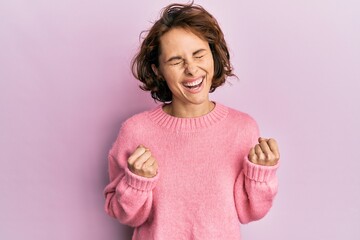 Sticker - Young brunette woman wearing casual winter sweater celebrating surprised and amazed for success with arms raised and eyes closed