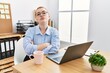 © Krakenimages.com - Young redhead woman working at the office using computer laptop skeptic and nervous, disapproving expression on face with crossed arms. negative person.