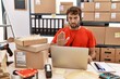 © Krakenimages.com - Young hispanic call center agent man working at warehouse doing stop sing with palm of the hand. warning expression with negative and serious gesture on the face.