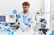 © Krakenimages.com - Young hispanic man wearing scientist uniform working at laboratory
