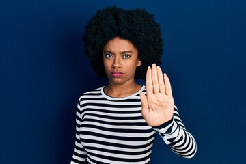 Wall Mural - Young african american woman wearing casual clothes doing stop sing with palm of the hand. warning expression with negative and serious gesture on the face.