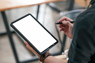 Wall Mural - man hand holding blank screen portable tablet and stylus pen.