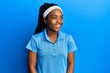 © Krakenimages.com - African american woman with braided hair wearing tennis player uniform looking to side, relax profile pose with natural face and confident smile.