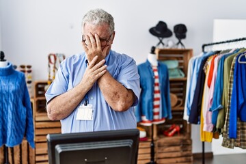 Sticker - Senior man with grey hair working as manager at retail boutique with sad expression covering face with hands while crying. depression concept.