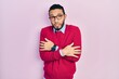 © Krakenimages.com - Hispanic man with beard wearing business shirt and glasses shaking and freezing for winter cold with sad and shock expression on face