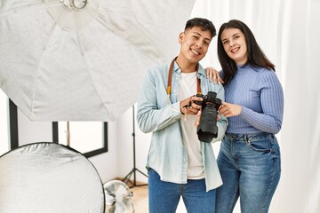 Poster - Professional photographer and model looking camera photos standing at photography studio.