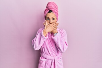 Wall Mural - Young blonde woman wearing shower towel cap and bathrobe shocked covering mouth with hands for mistake. secret concept.