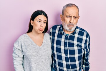 Sticker - Hispanic father and daughter wearing casual clothes depressed and worry for distress, crying angry and afraid. sad expression.