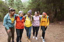 Group Of Women With Different Ages And Ethnicities Having Fun Walking In The Woods - Adventure And Travel People Concept