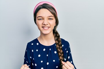 Sticker - Young brunette girl wearing elegant look very happy and excited doing winner gesture with arms raised, smiling and screaming for success. celebration concept.