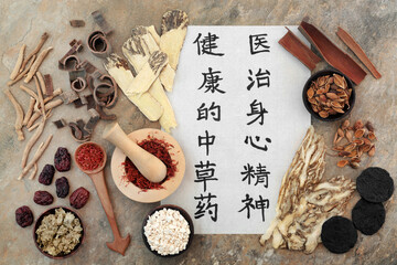 Poster - Ancient Chinese herbal medicine with herbs, spice and calligraphy script on rice paper. Translation reads as traditional Chinese herbs to heal mind body and spirit. Natural health care concept.