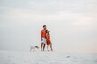 © omelnickiy - young couple in orange clothes with dog