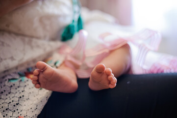 closeup feets of the child on the parent