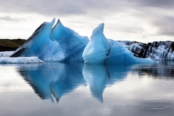 Wall Mural - beautiful blue icebergs reflected in the jokulsarlon glacial lagoon, southern iceland. part of the v