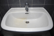 Dirty Bathroom Fixtures, White Sink And Chrome Faucet. The Difference Before And After Cleaning