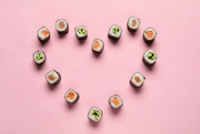 Heart Shaped Frame Made Of Delicious Maki Sushi On Color Background
