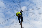Fototapeta  - Telecommunications, telecom engineer at work on the top of a telegraph pole