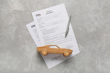 Poster - Rental agreements, wooden car and pen on grey background