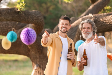 Wall Mural - Happy man and his father drinking beer at barbecue party on summer day