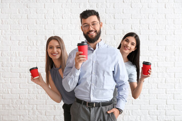 Canvas Print - Business people with coffee on white brick background