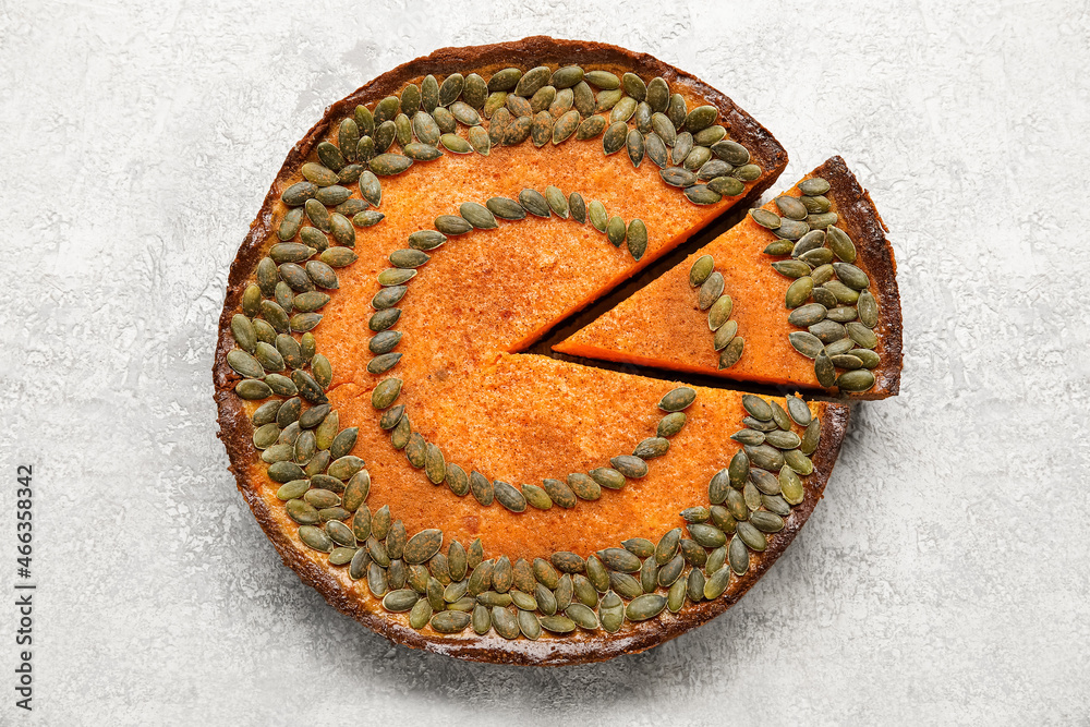Delicious pumpkin pie on light background