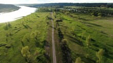 Empty Modern Bicycle Pathway In Green Landscape Near River, Aerial Drone View