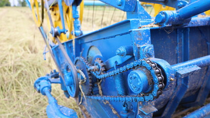 Wall Mural - Chain with old sprockets. Close up dirty chains with grease that drives the combine harvester rotary system. Selective focus