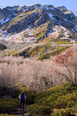 A man goes to the mountains. Travel to the mountains on foot. Arkhyz. The Caucasus Mountains. Russia.