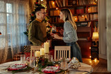 Fototapeta Paryż - Couple enjoying Christmastime at home