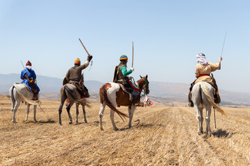 Wall Mural - Horse and foot warriors - participants in the reconstruction of Horns of Hattin battle in 1187, are on the battle site, near TIberias, Israel