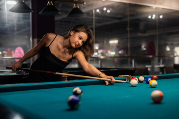 Wall Mural - Pretty woman spend free time playing billiard snooker at pub