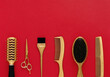 Background with hairdressing tools on red. Hair salon accessories gold, hair combs, scissors. Banner and template for design with space for text