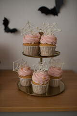 Halloween decoration, sweet table, cupcakes. The decor of a children's holiday.