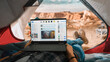 © Gorodenkoff - POV of a Tourist Using a Laptop Computer for Checking Social Network Feed and Latest Photos. Traveller Resting in a Tent on Top of Rocky Mountain. Adventurous Hiker Living in Nature in Great Outdoors.