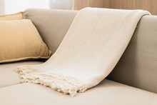 White Woven Throw Blanket On Sofa