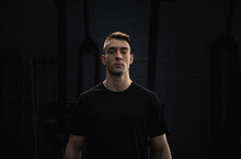 Confident Male Athlete In Front Of Black Wall